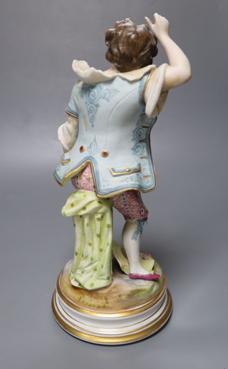 A 19th century French bisque figure, 32cm and two Vienna-style wall plates, 22cm